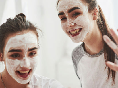 Teenage girls wearing a white face mask