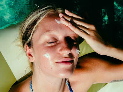 woman putting sun cream on her face