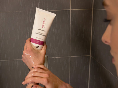 woman using a Green people body scrub on her hands and arms