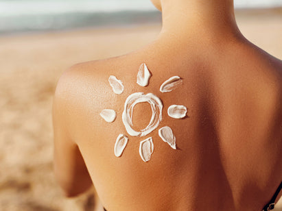 woman with sun cream on her back