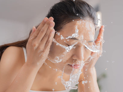 woman washing her face