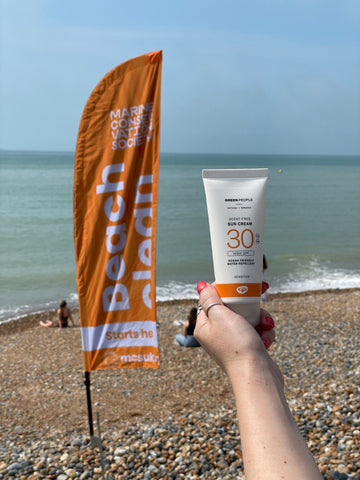 Green People sun cream on Brighton beach
