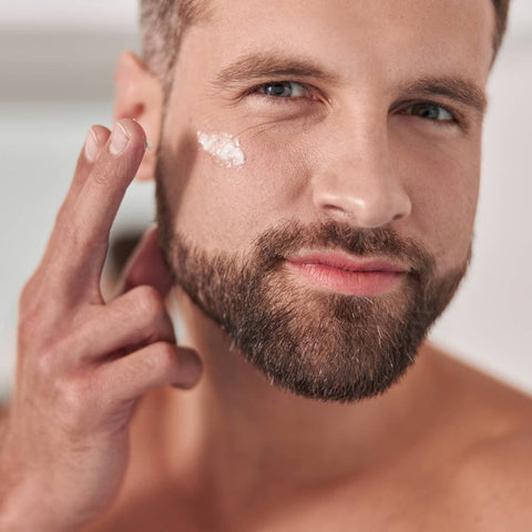 Man applying eye cream