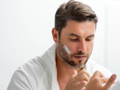Man applying sun cream to his beard