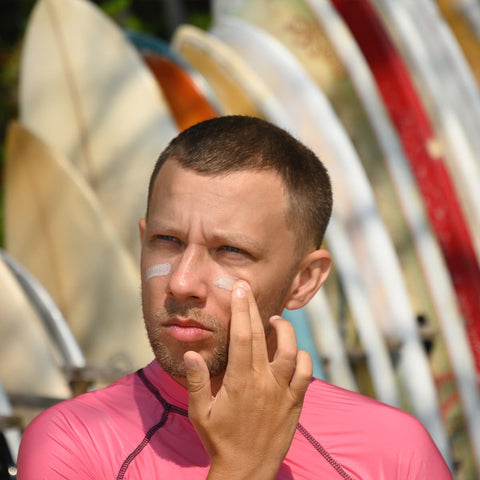 surfer applying sunscreen